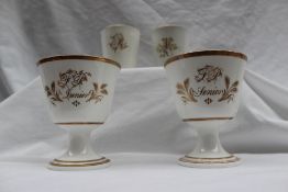 A pair of 19th century porcelain beakers, one initialled 'M', the other 'R',