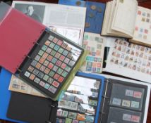 A collection of world stamps contained in six albums together with assorted coins