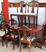 A reproduction mahogany extending dining table and six chairs