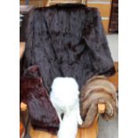 A white fox fur stole together with a fur coat,