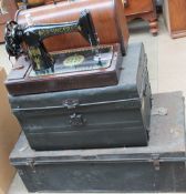 A Singer sewing machine together with two tin trunks