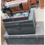 A Singer sewing machine together with two tin trunks