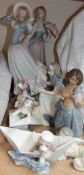 A Lladro figure of a lady holding an umbrella together with six other Lladro figures