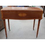 A Regency style mahogany Pembroke table with satinwood roundels and cross banding on square