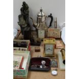 A Mappin and Webb carriage clock together with another carriage clock, bronzed family group statue,