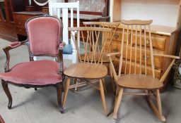 An Ercol light teak rocking chair together with a pair of teak dining chairs an upholstered elbow