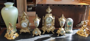 A modern gilt metal and pottery clock garniture together with a gilt metal mantle clock,