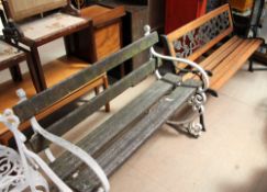 A white painted and slat garden bench together with another garden bench