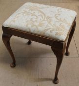 A 20th century upholstered walnut dressing table stool