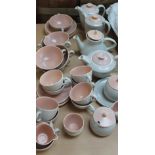 A Poole pottery part tea set with peach interior and lids