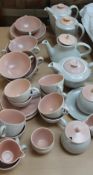 A Poole pottery part tea set with peach interior and lids