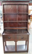 A 20th century oak dresser, the rack with a moulded cornice and three shelves,