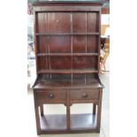 A 20th century oak dresser, the rack with a moulded cornice and three shelves,