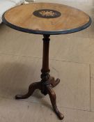 A late Victorian inlaid wine table with a circular top on a tapering column and three legs