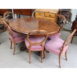 A Victorian burr walnut oval topped supper table together with six Victorian balloon back dining
