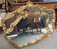 A pair of gilt decorated wall mirrors together with a collection of gilt wall mirrors