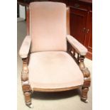 A late Victorian oak library chair with an upholstered back,