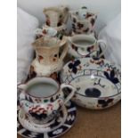 A collection of Gaudy Welsh pottery jugs and bowls