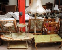 An Onyx coffee table with two tiers and oval tops together with a pair of wine tables,