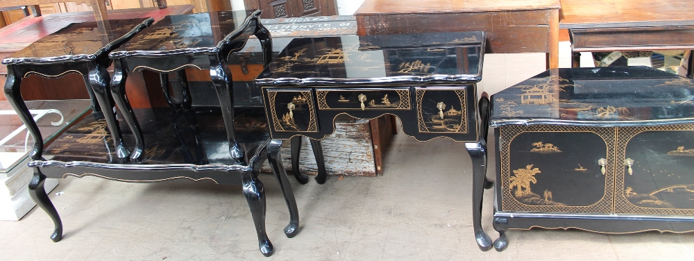 A suite of Oriental inspired furniture with black lacquer and gilt decoration depicting pagodas and