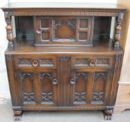 A 20th century oak court cupboard with a central cupboard,