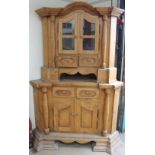 A large German pine standing corner cupboard with a glazed top with drawers,