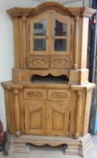 A large German pine standing corner cupboard with a glazed top with drawers,