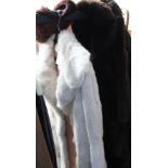 A fur coat together with other fur coats,