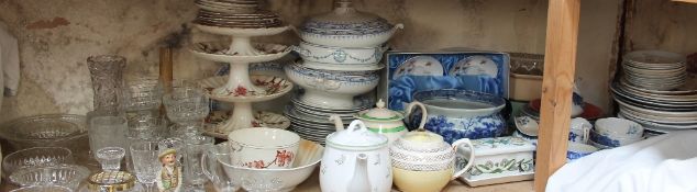 A blue and white porcelain pot together with teapots, tureens and covers, assorted pottery plates,