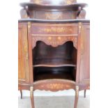 A 19th century mahogany chiffonier, the shield shaped upstand with a central mirror and shelf,