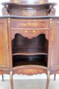 A 19th century mahogany chiffonier, the shield shaped upstand with a central mirror and shelf,