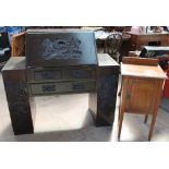 A Chinese carved hardwood bureau with a sloping fall and two pedestals with an arrangement of