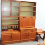 A G-Plan teak wall unit together with a matching wall unit with drinks cabinet inset and a teak