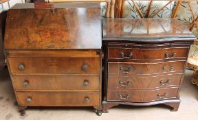 A reproduction walnut bureau together with a side cabinet in the form of a serpentine chest of