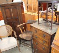 An elm seated captain's chair together with an oak cupboard, a bergère backed elbow chair,