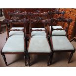 A set of six Regency rosewood dining chairs with a scrolling and leaf top rail,