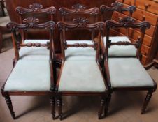 A set of six Regency rosewood dining chairs with a scrolling and leaf top rail,