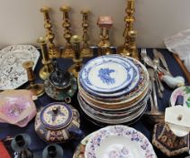 Brass candlesticks together with pottery plates, teapots,