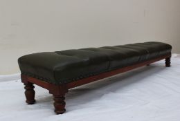 A Victorian kneeling stool with a button upholstered cushion on four ring turned legs,