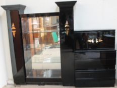 A modern black lacquer display cabinet together with side cabinets,