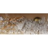 A large quantity of crystal and gilt decorated drinking glasses, decanter, rose bowl,