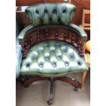 A green leather button upholstered office chair