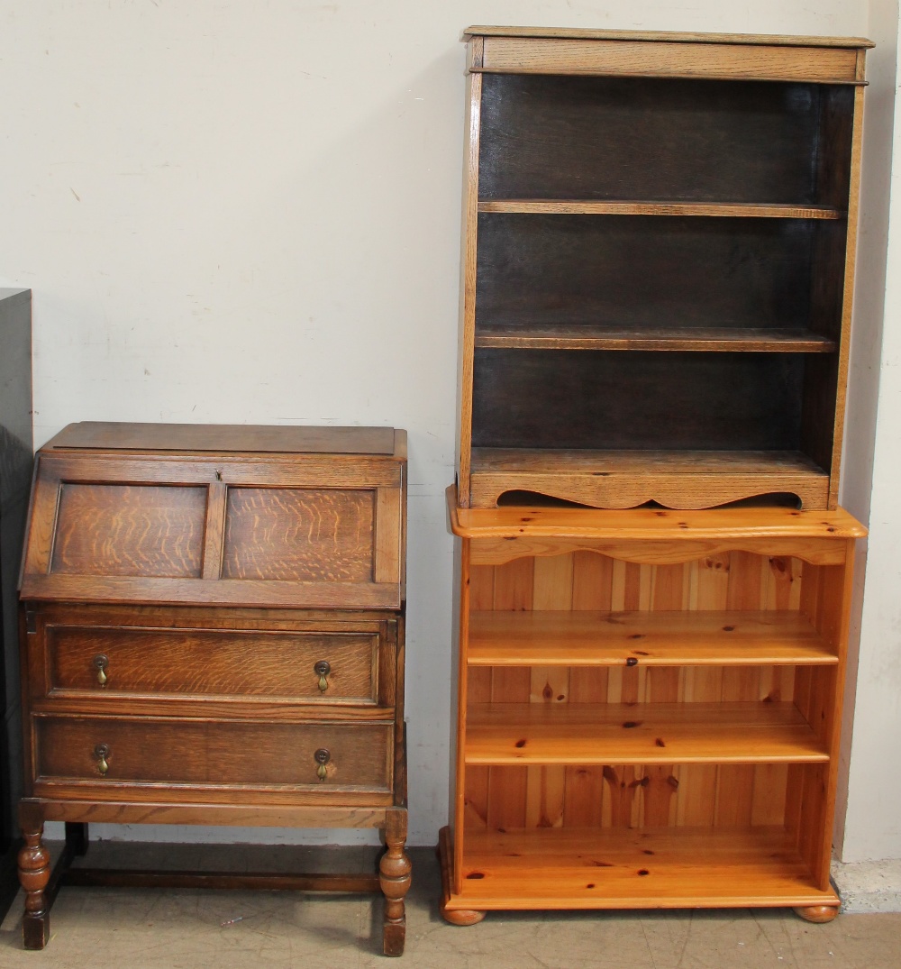 A 20th century oak bureau together with an oak bookcase and a pine bookcase