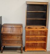 A 20th century oak bureau together with an oak bookcase and a pine bookcase