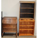 A 20th century oak bureau together with an oak bookcase and a pine bookcase