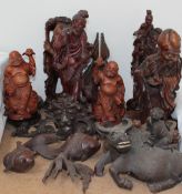 A collection of carved Oriental figures and fish, including koi carp, boy on a buffalo, dignitaries,