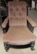 A Victorian mahogany library chair with a scrolling button back,