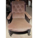 A Victorian mahogany library chair with a scrolling button back,
