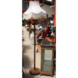 A modern display cabinet with a square mirrored top together with a standard lamp