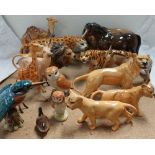 A large quantity of Beswick figures including lions, leopard, tiger, kingfisher, barn owls, stag,
